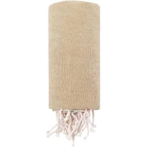 A cylindrical tan towel with white tassels at the bottom, featuring a logo.