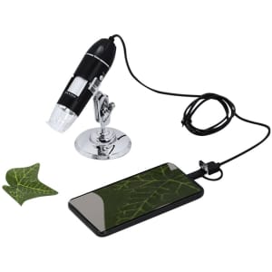 A black microscope with chrome stand, connected to a device featuring a green leaf design.