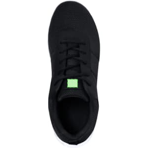 A pair of black trainers with a mesh upper and a green square logo on the tongue.