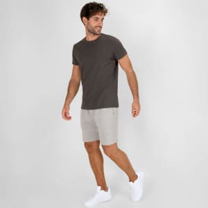 Bermuda shorts in a light grey fabric paired with a fitted dark grey t-shirt and white sneakers.
