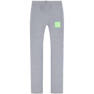 Grey joggers with a fitted design and a small logo patch in a bright green colour.