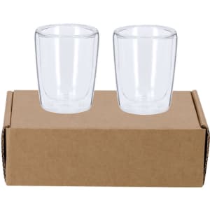 A set of two clear glass cups placed on a cardboard box, featuring a simple design.