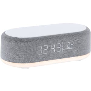 A grey multifunction alarm clock with a digital display and a light base. It features a soft fabric texture.