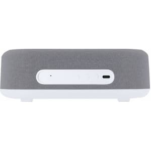 A multifunction alarm clock in grey fabric with a white base, featuring a control panel and a charging port.