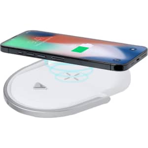 A wireless charger in white and silver, featuring a smartphone placed on top, showing a charging indicator.