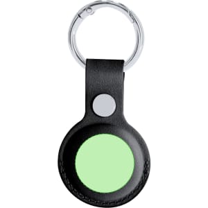 A black leather keychain holder featuring a round green insert and a metal keyring attachment.