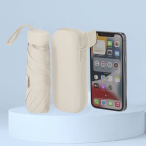 A cream-coloured foldable umbrella with a matching case beside a smartphone displaying various apps.
