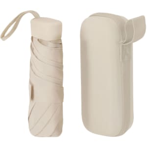 A foldable umbrella in beige, stored in a compact case with a strap. The case features a secure closure.