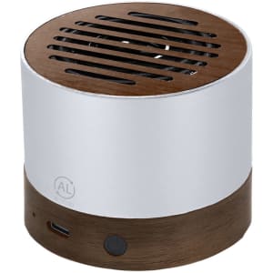 A round speaker in silver and brown, featuring a slotted top and a logo on the side.