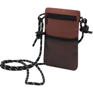 A multipurpose bag featuring a brown top section and a black spotted bottom, with an adjustable strap and a zippered pocket.