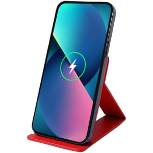 A wireless charger in red with a smartphone positioned upright, displaying a charging symbol on the screen.