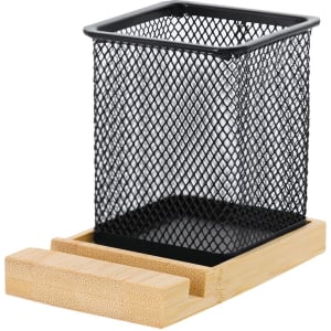 A black mesh pencil holder sits on a bamboo tray, featuring a minimalist design with a square structure.