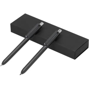 A black gift box containing two sleek black pens with silver accents.