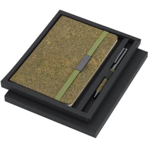 A green notebook with an elastic band and a pen, packaged in a black gift box.