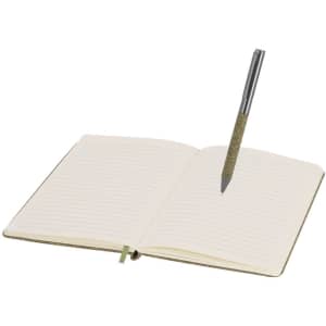 An open notebook with blank pages and a grey pen resting on it, featuring a glittery barrel.