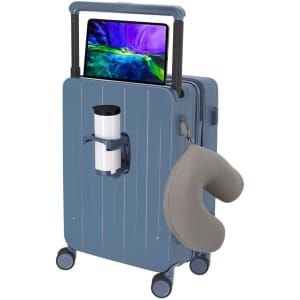 A blue wheeled bag with a handle, featuring a cup holder and a grey neck pillow, along with a tablet resting on top.