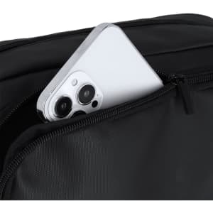 A black toiletry bag featuring a zippered pocket with a white smartphone partially visible inside.
