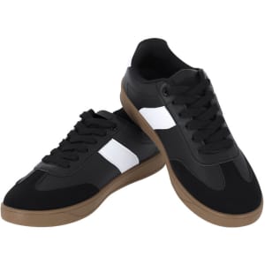 A pair of black trainers with white stripes and a gum sole, featuring laces and a logo on the side.