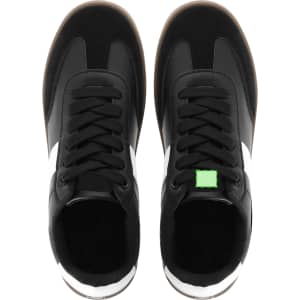 Footwear featuring black and white trainers with a green accent, designed for comfort and style.