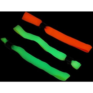 Three vibrant wristbands in orange and green, featuring a flexible design with black connectors, set against a dark background.