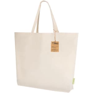 A beige tote bag with sturdy handles and a tag attached. The bag has a simple design and a logo.