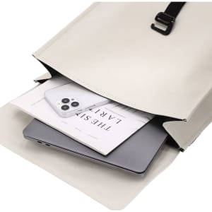 A cream backpack with a laptop and a smartphone inside, featuring an interior pocket and a strap.