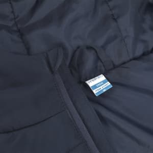 A navy puffer jacket featuring a zipper and a tag with branding. The material appears quilted.