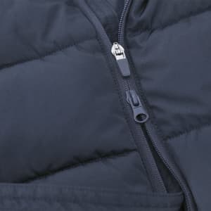 A close-up of a navy blue puffer jacket featuring a zippered front and quilted texture. The jacket includes a branding logo.