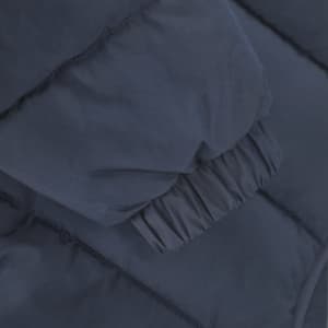 Navy puffer jacket sleeve detail with gathered cuff and quilted texture. Includes a logo.
