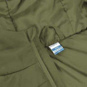 An olive green puffer jacket with a zipper and a tag displaying product information.