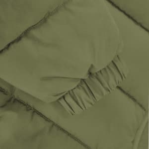 A puffer jacket sleeve in a muted green shade, featuring gathered cuffs for a snug fit.