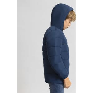 A navy blue puffer jacket with a hood, featuring a child model side profile. It has a logo on the jacket.