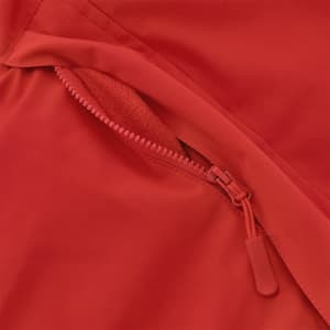 A close-up of a red puffer jacket featuring a zippered pocket with a soft lining. The jacket has a sleek design.