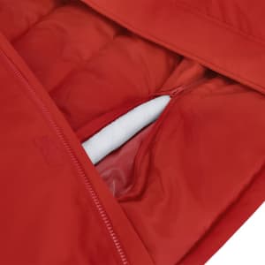 A red puffer jacket featuring a zippered pocket and a soft inner lining. It has a logo on the outer fabric.