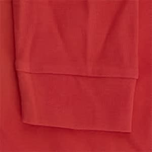 A red polo shirt featuring a soft fabric texture and a rolled sleeve hem. It includes a logo on the chest area.