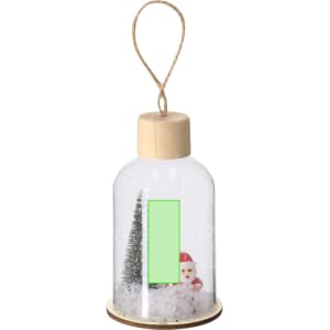 A clear decorative bottle featuring a snowman and miniature trees inside, with a wooden base and twine hanger.