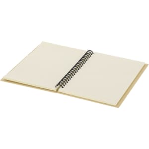 An open cream-coloured notebook with a spiral binding, featuring blank lined pages inside.