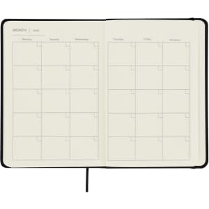 A notepad with a black cover and blank monthly planning pages, featuring spaced sections for days of the week.