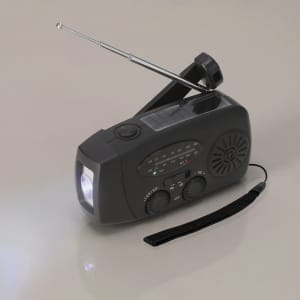 A black multifunction emergency radio with an antenna, flashlight, and adjustable dials, featuring a logo.