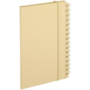 A beige Gambel Planner Notebook with a spiral binding and an elastic closure. Features a simple design and a branding logo.