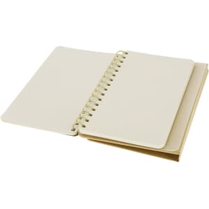 A spiral-bound notebook with a beige cover and blank pages, featuring a gold coil binding.