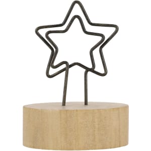 A star-shaped wire holder mounted on a wooden base. The base is light wood, and the wire is black.