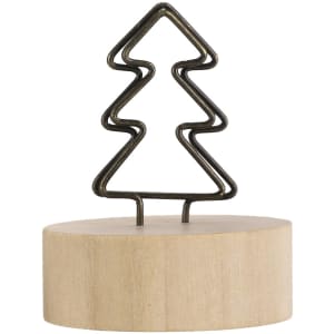 A decorative desk clip featuring a metal tree design atop a wooden base. The tree is in a bronze finish.