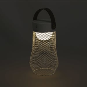 A mesh lantern with a black top and handle, featuring a warm white light inside, glowing in a dark setting.