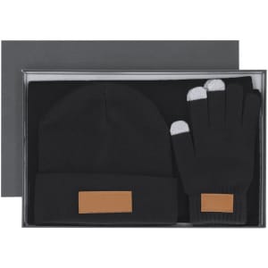 A black beanie and gloves set, featuring a leather tag, presented in a box.