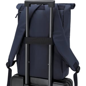 A navy blue backpack with padded straps is attached to a suitcase handle, showcasing its sleek design.