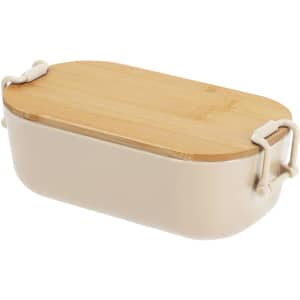 A beige lunch box with a bamboo lid and white handles. The design is sleek and modern.