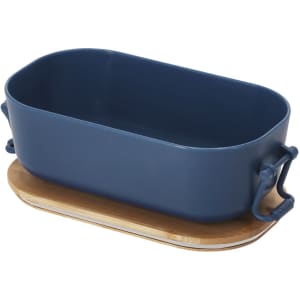 A navy blue lunch box with handles and a wooden base, designed for carrying food items.