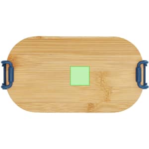 A bamboo lunch box with blue handles, featuring a small green square on top.