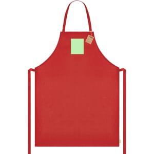 A red apron with a green square patch and ties for adjustment, featuring a branding label.